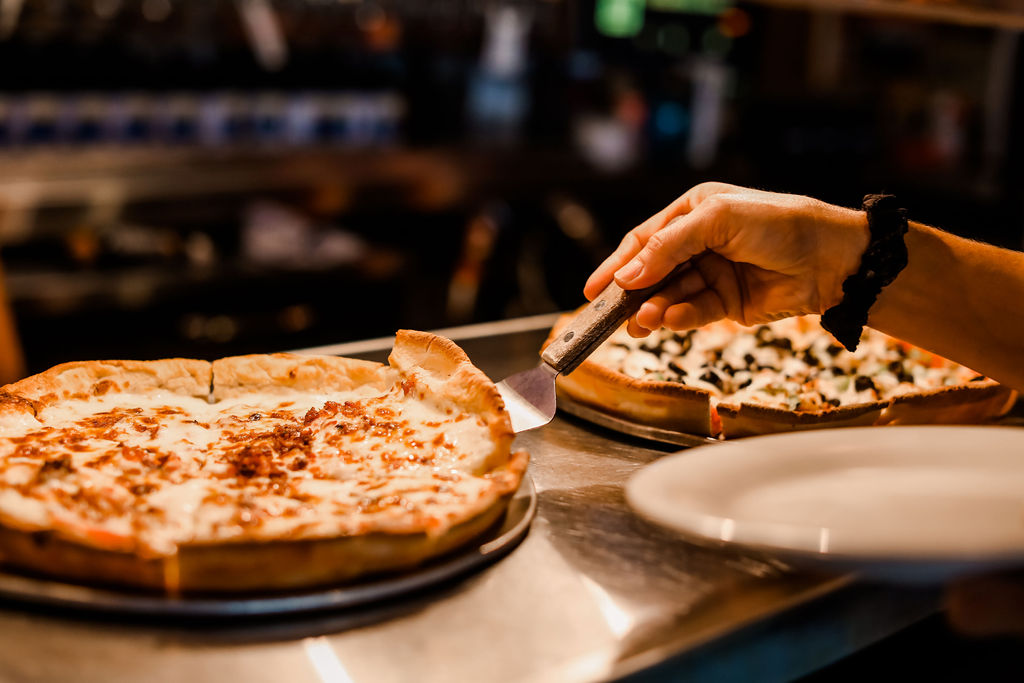 two sliced pizzas