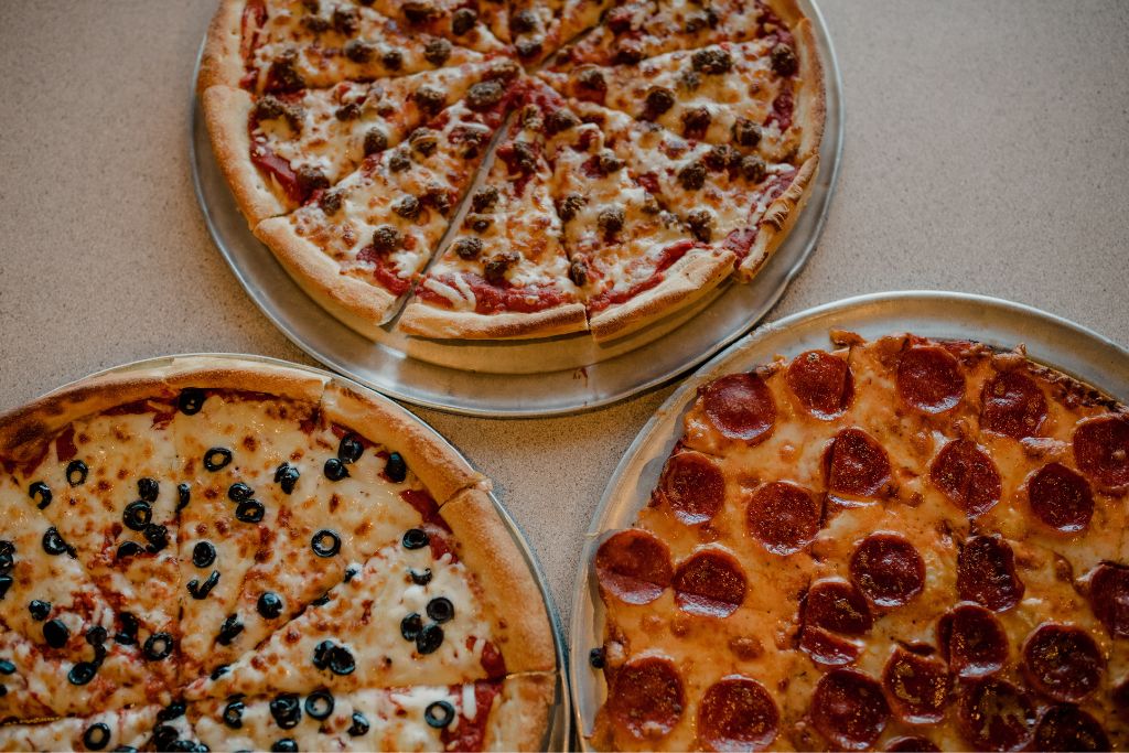 three different styles of pizza