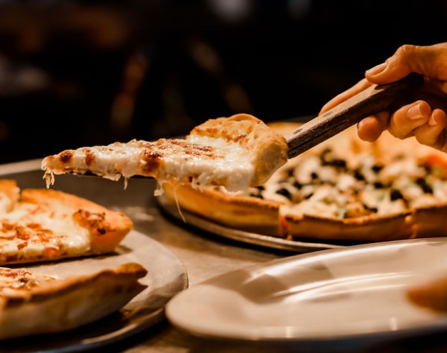 serving pizza at a table