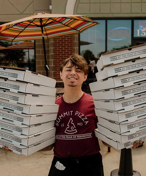 Summit staffer leaving the building with pizzas