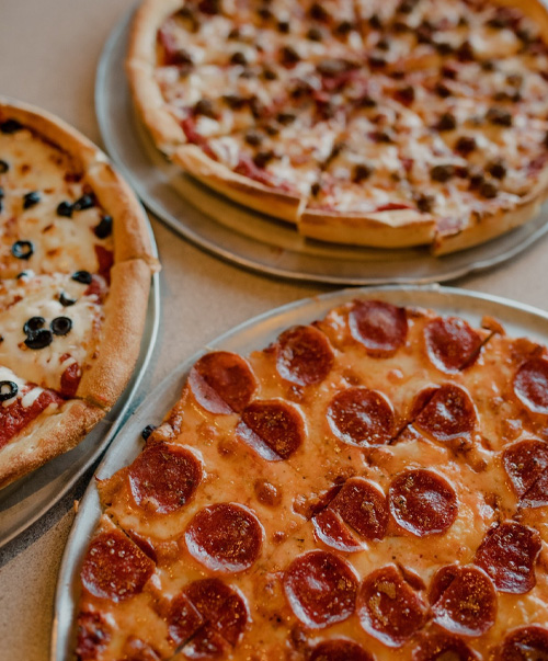 3 pizzas including pizza and one with black olives